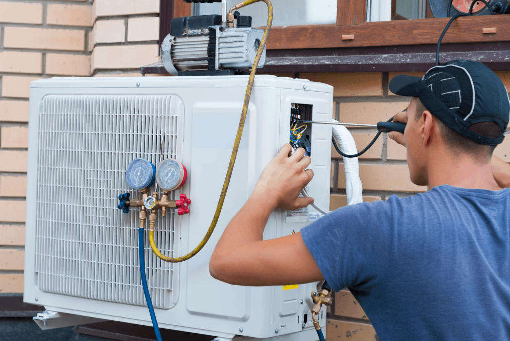 Técnico arreglando unidad de aire acondicionado exterior